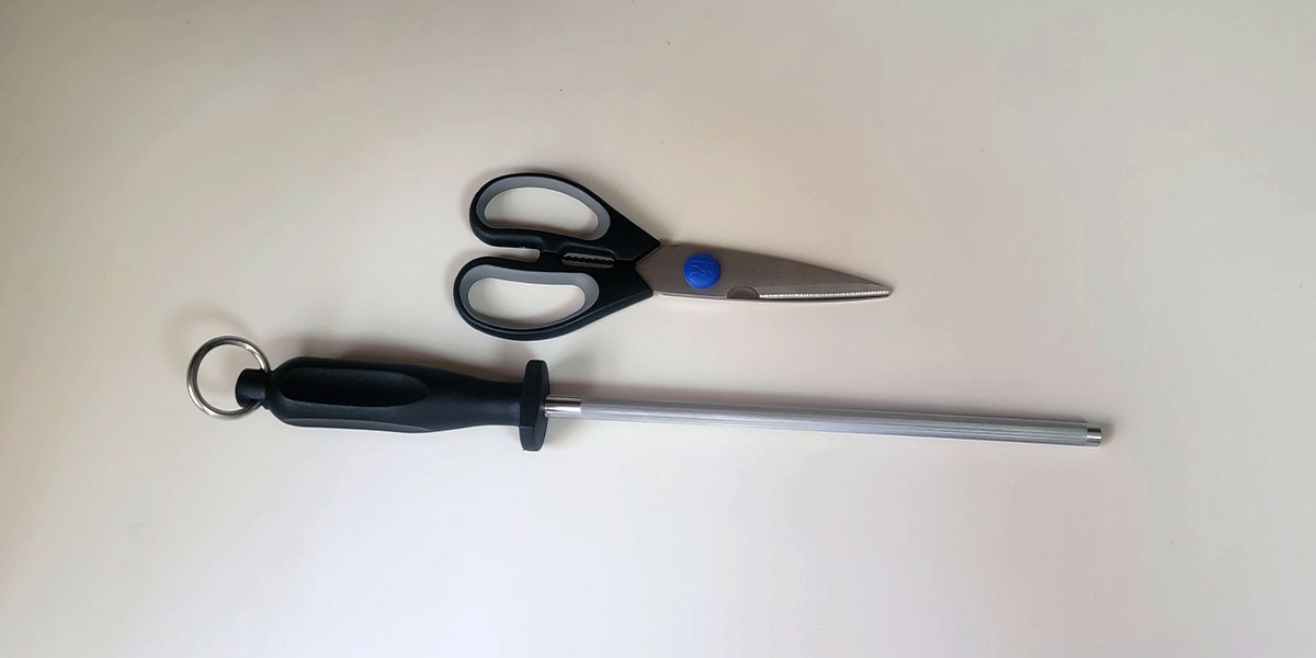 Henckels scissors and honing steel displayed horizontally on counter Henckels scissors and honing steel displayed horizontally on counter