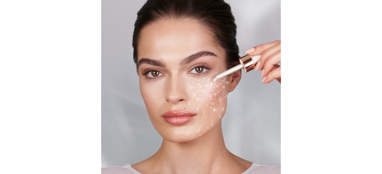 Woman applying Charlotte Tilbury Magic Serum Crystal Elixer to cheek